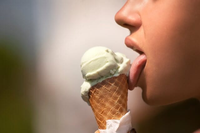 Girl licking ice cream on fresh air